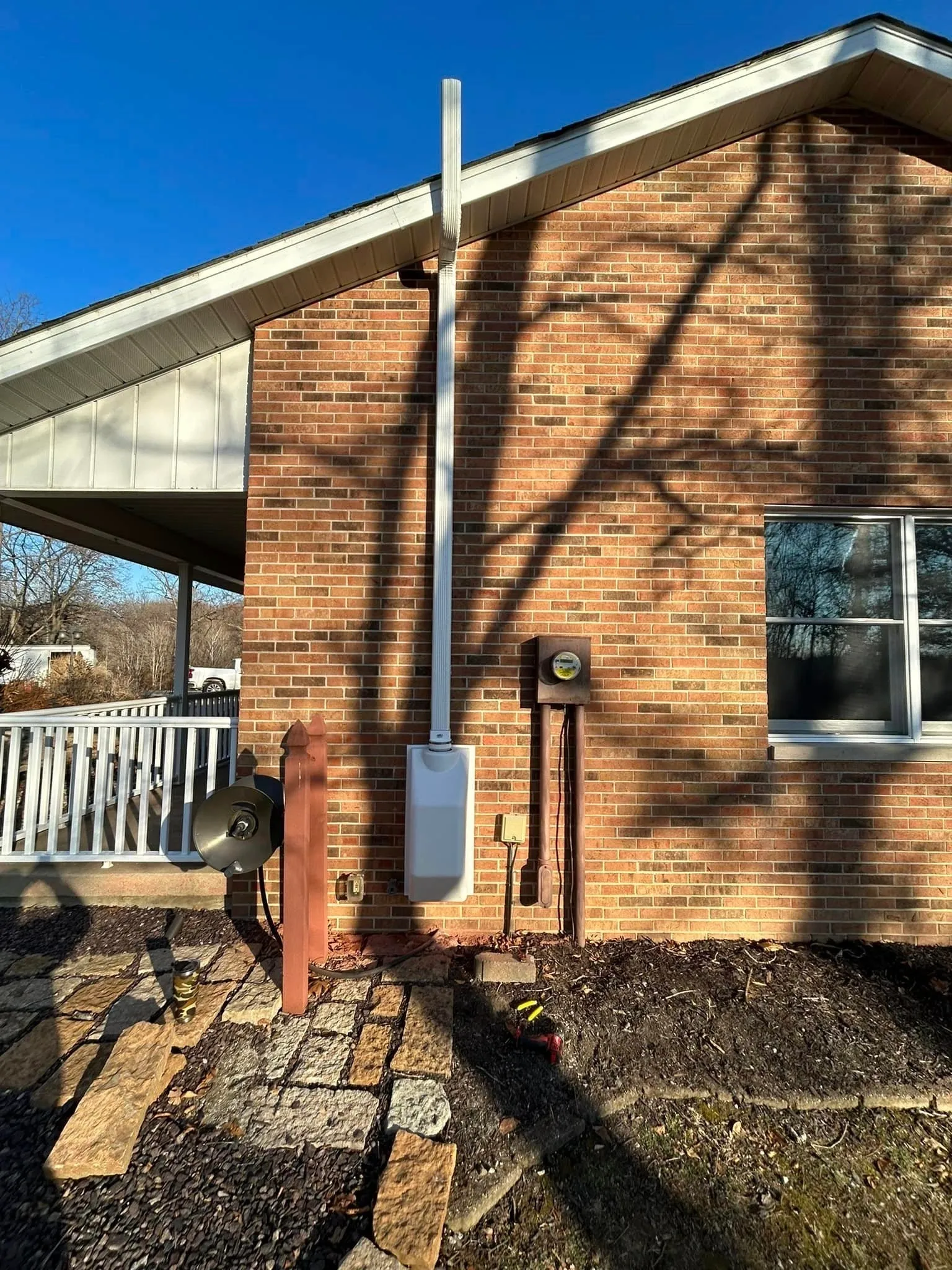 Radon vent pipe on a brick exterior